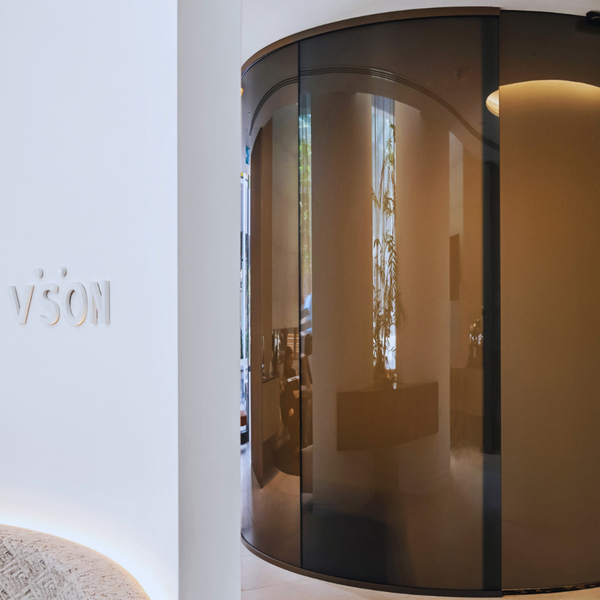 Curved grey switchable glass fixed panel at Vson Laser Eye Surgery Brisbane, showcasing smart privacy glass technology and contemporary healthcare interior glazing.