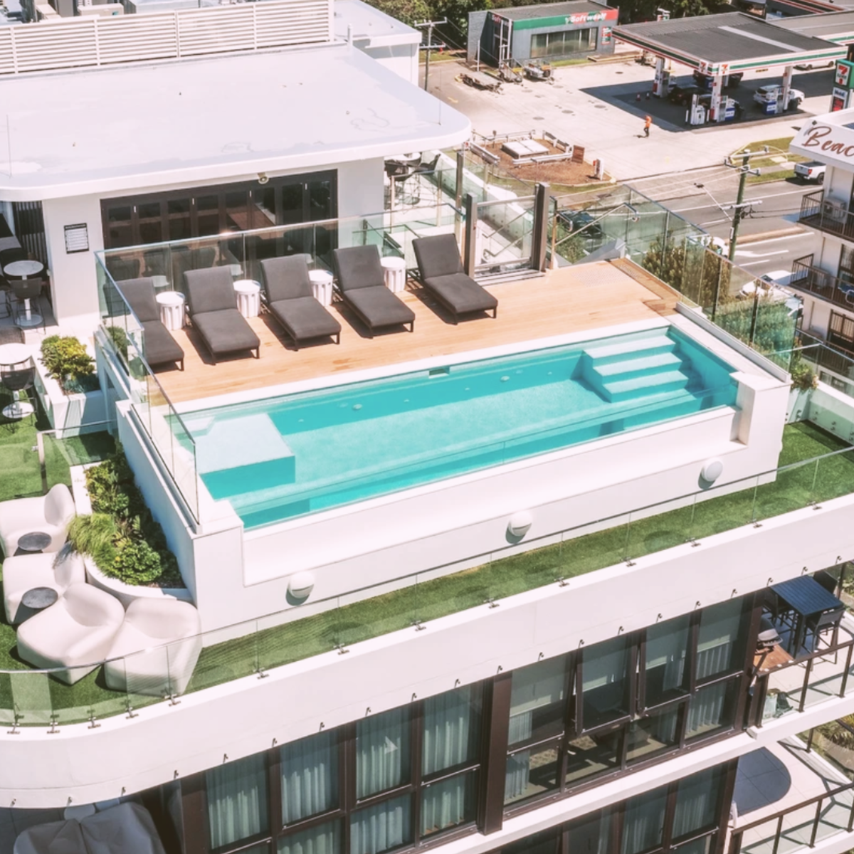 Side view of swimming pool with structural laminated glass wall in Gold Coast home