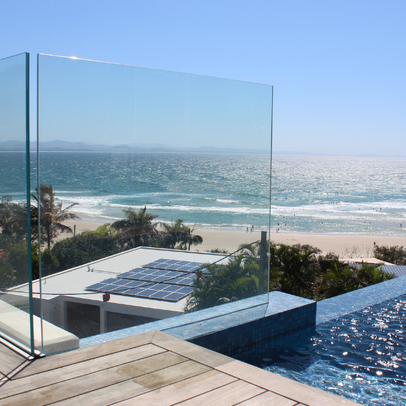 Swimming pool frameless balustrading over looking byron bay