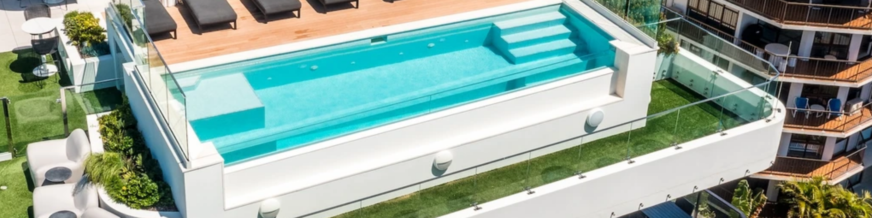 Structural aminated swimming pool window on the roof top of this commercial building