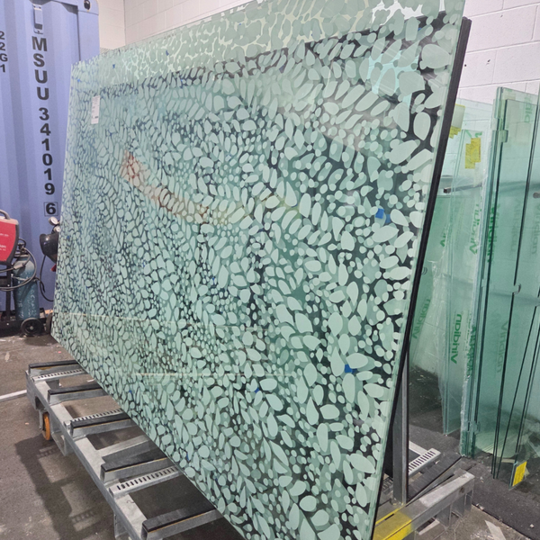 13.52 mm ceramic-printed toughened laminated glass panels used as overhead roof glazing, highlighting architectural glass design, durability, and sun control for retail spaces.