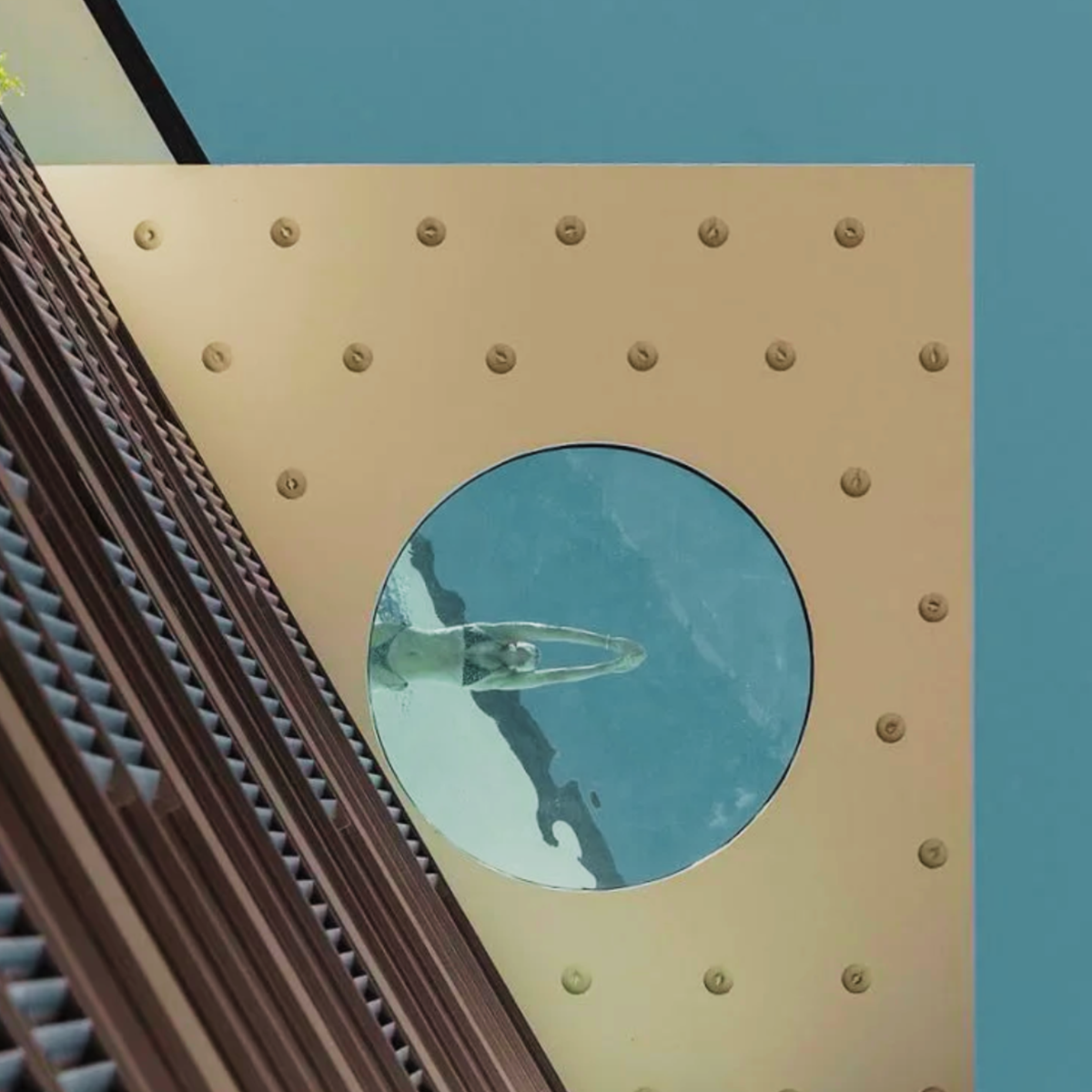 Suspended low-iron structural glass floor installed over a commercial swimming pool at Luminare Apartments, showcasing crystal-clear transparency and modern architectural design.