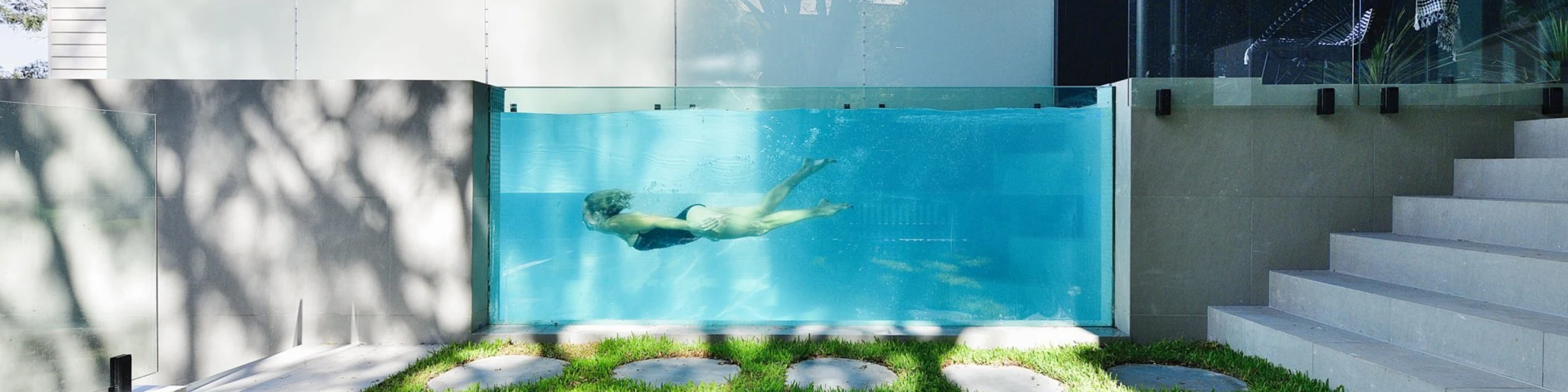 Triple laminated structural glass pool window in a residential home