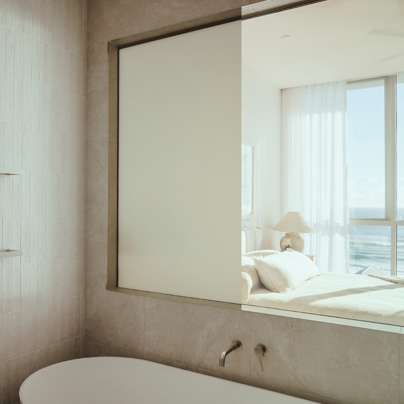 Privacy using switchable glass between a bathroom and bedroom