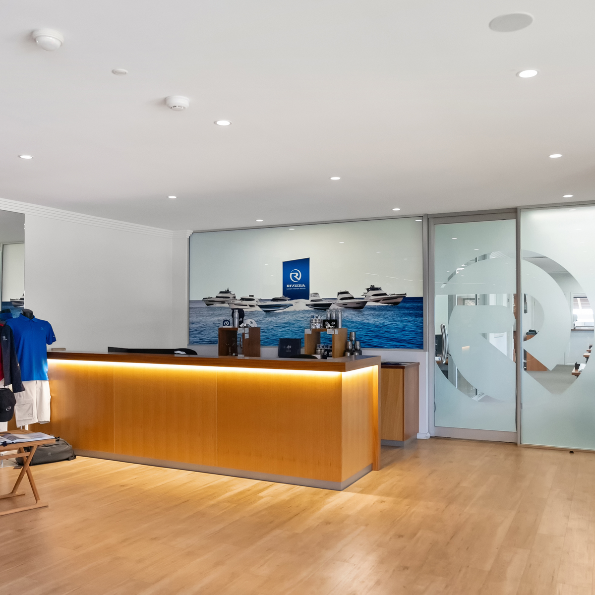 Interior view of Riviera 60SY master stateroom with smart glass panel, demonstrating advanced laminated switchable glass and marine-grade glazing.