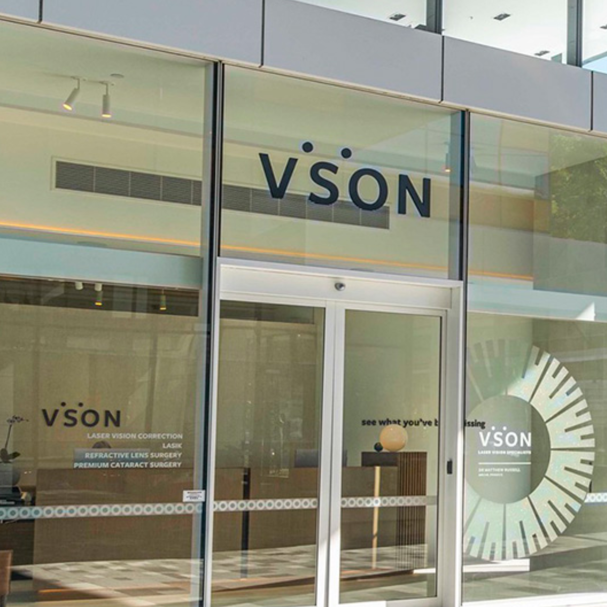 Interior view of a laser eye surgery clinic using switchable smart glass walls, highlighting curved architectural glazing, privacy glass solutions, and modern medical fit-out design.