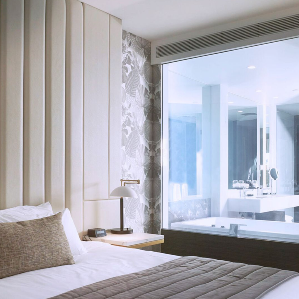 Clear-to-opaque switchable laminated glass in a hotel suite, showcasing low-iron glass clarity and contemporary interior privacy solutions.