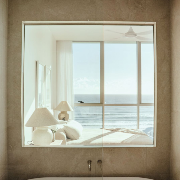 Bathroom and bedroom separated by clear switchable laminated glass in luxury Palm Beach residence