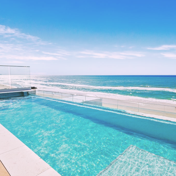Infinity-edge pool featuring clear structural glass window on the Gold Coast