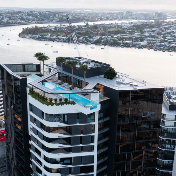 ommercial glass pool floor installation in a luxury apartment complex, showcasing suspended glass flooring, natural light transmission, and modern architectural design