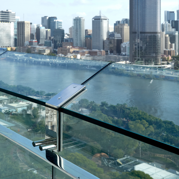 Modern rooftop terrace featuring engineered laminated glass balustrade along city skyline edge